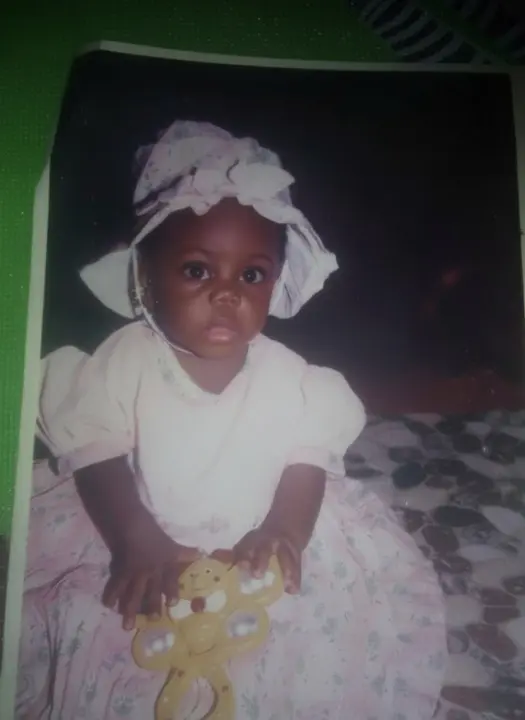 Blessing as a child smiling in a cute birthday dress